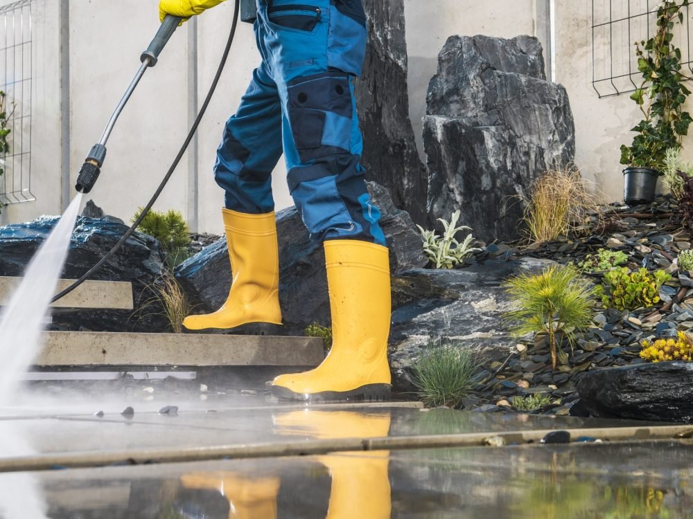 Men Pressure Washing His Garden Architectural Concrete Elements