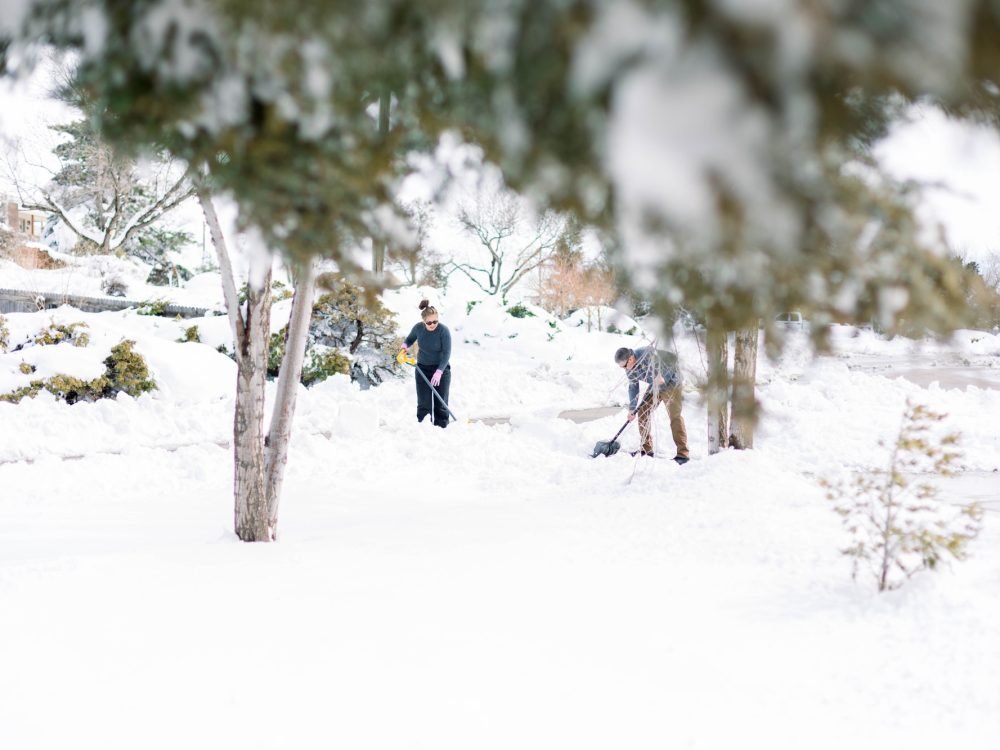People shoveling snow after a snow storm